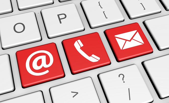 Close-up of laptop keyboard keys focusing on three red keys with symbols for @, phone and envelope